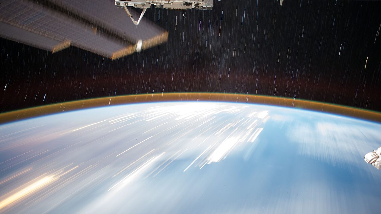 Long-exposure night photograph taken from the International Space Station on 4 July 2017: a starry sky above the curve of the Earth over Africa and the Indian Ocean, with part of the station's Kibo module and solar array at the top edge.