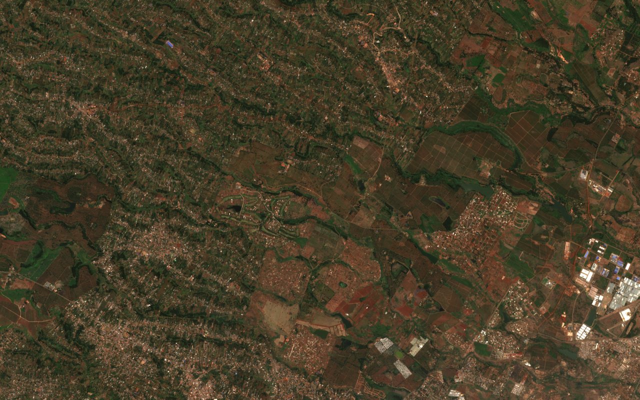 Sentinel-2 true-colour view of land north of Nairobi on 12 August 2026: a mix of housing, rectangular farm plots in green and brown, and a cluster of large white and blue warehouse roofs.