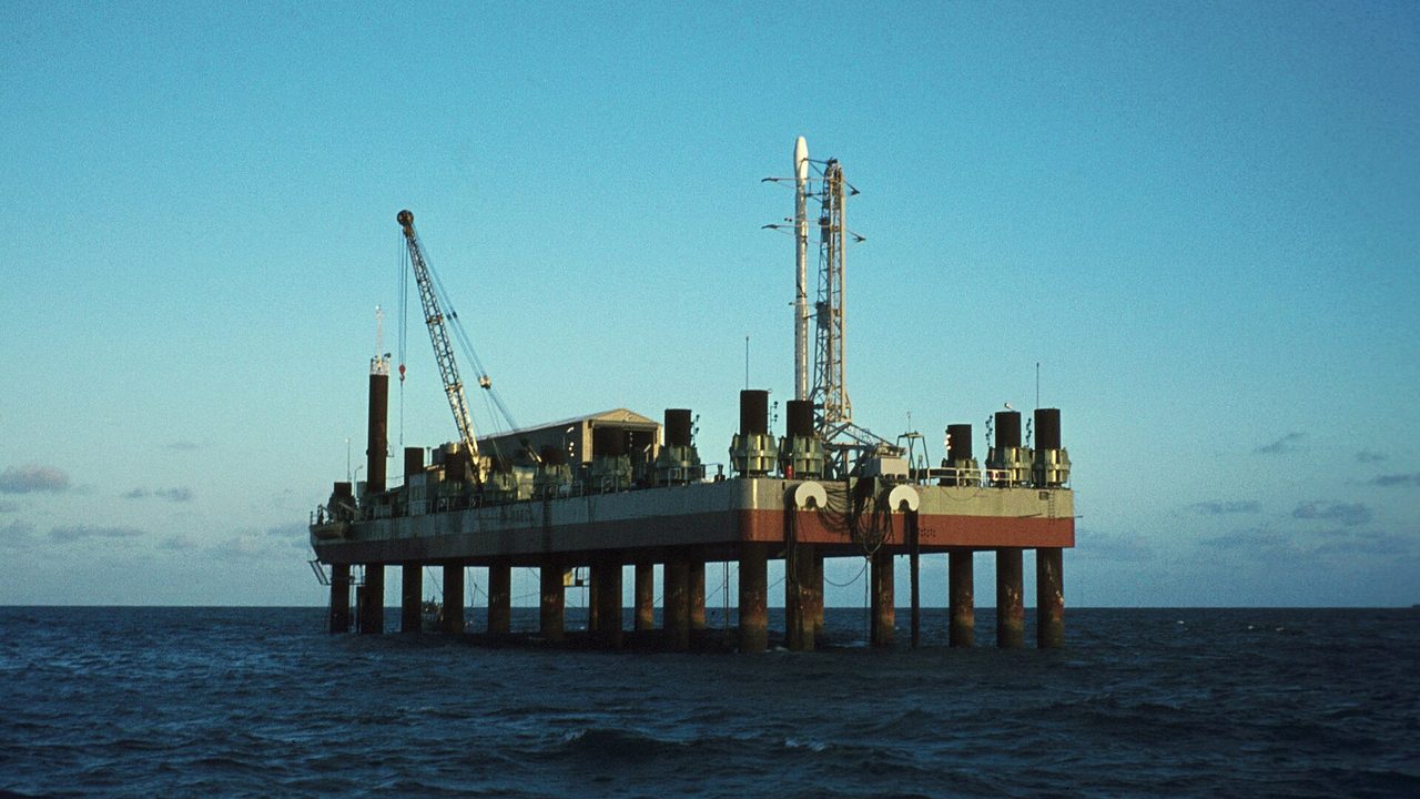 The San Marco launch platform, an oil-rig style structure with masts, a crane and a helicopter deck standing in calm sea off the Kenyan coast near Malindi.